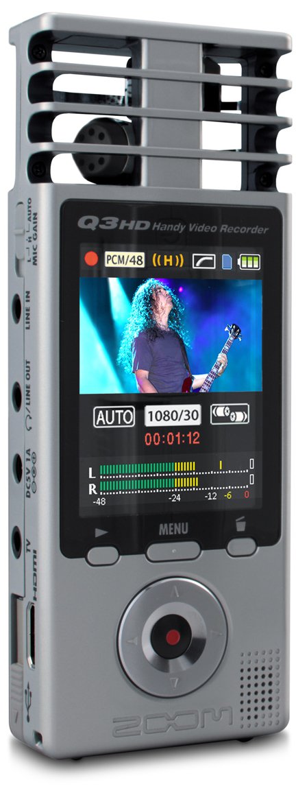 Zoom Q3HD Handy Video Recorder showing a musician performing on its LCD screen. The device features control buttons, ports on the side, and a distinctive microphone grille at the top.