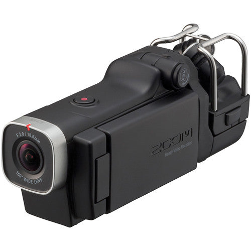 Angled view of the Zoom Q8 Handy Video Recorder with the attached top-mounted microphone, LCD screen closed, and the wide-angle lens highlighted in the front.