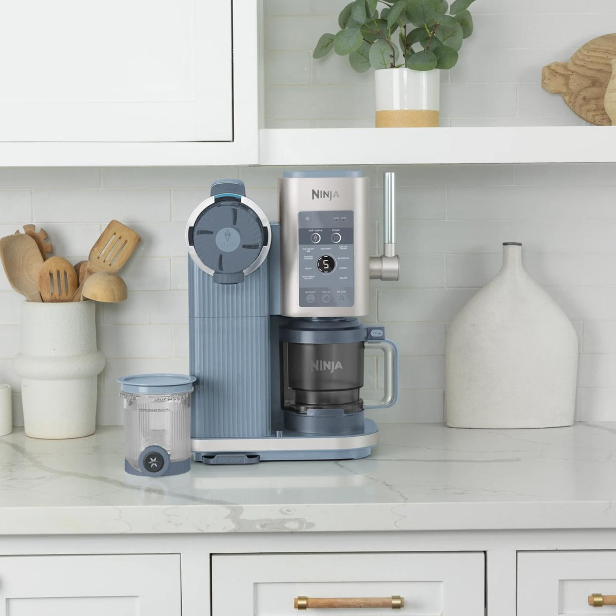 Ninja CREAMi Scoop & Swirl NC702EU Steel Blue with CREAMi 2-in-1 tub on a marble counter