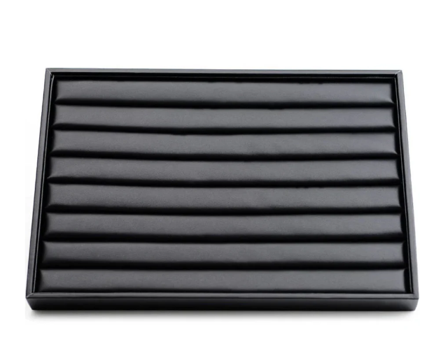 Empty velvet jewelry organizer tray with padded grooves for rings and earrings.