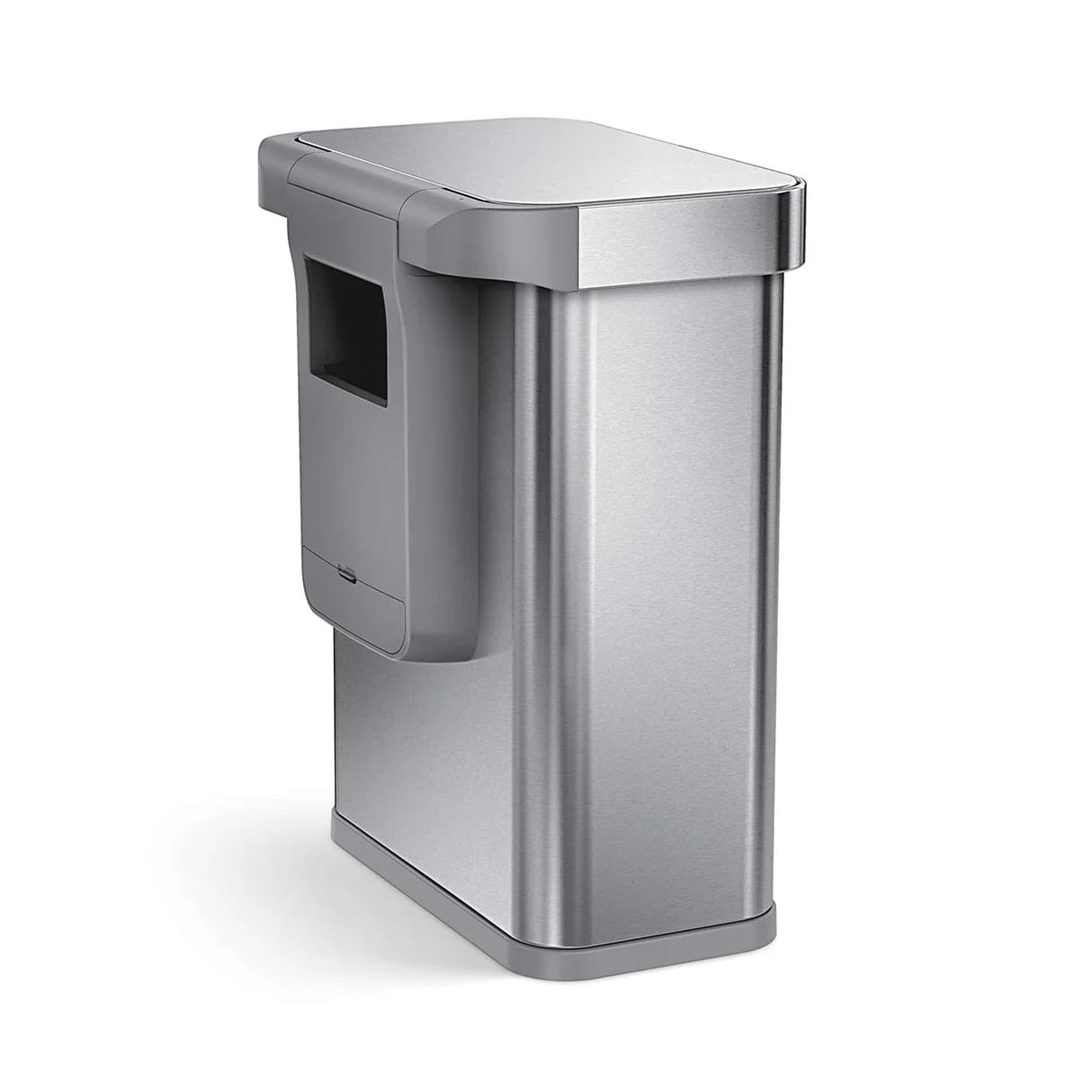 The image shows a Simplehuman trash can with a sleek, rectangular design and a brushed stainless steel finish. The trash can features a compartment at the back, likely for storing extra trash bags or other accessories, integrated into the design. The overall look is modern and minimalist, emphasizing both functionality and aesthetic appeal. The design is consistent with Simplehuman's reputation for creating high-quality, user-friendly home products.