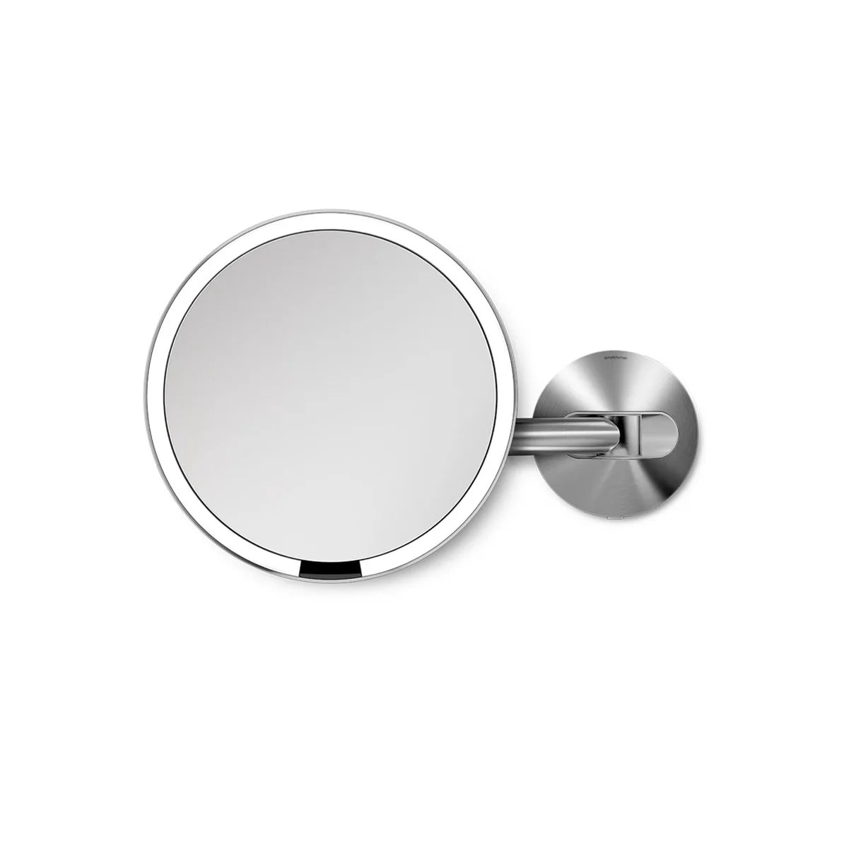 The image shows a round wall-mounted mirror with a sleek, polished silver frame. The mirror is attached to an adjustable arm and mount, also in a matching silver finish. The design is minimalist and modern, making it a stylish addition to any bathroom or vanity area. The adjustable arm allows for easy positioning, making the mirror ideal for tasks such as grooming or makeup application. The polished silver finish adds a clean and sophisticated touch to the overall design.