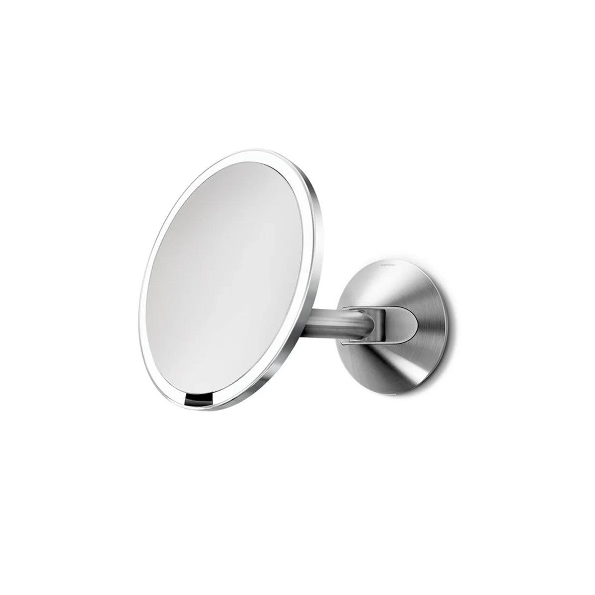 The image displays a round wall-mounted mirror with a polished silver frame and an adjustable silver arm and mount. The mirror is angled slightly, showcasing its ability to pivot and adjust for different viewing angles. The sleek and modern design, combined with the silver finish, makes this mirror an elegant addition to any bathroom or vanity area. Its functionality and stylish appearance make it ideal for tasks such as grooming or makeup application.