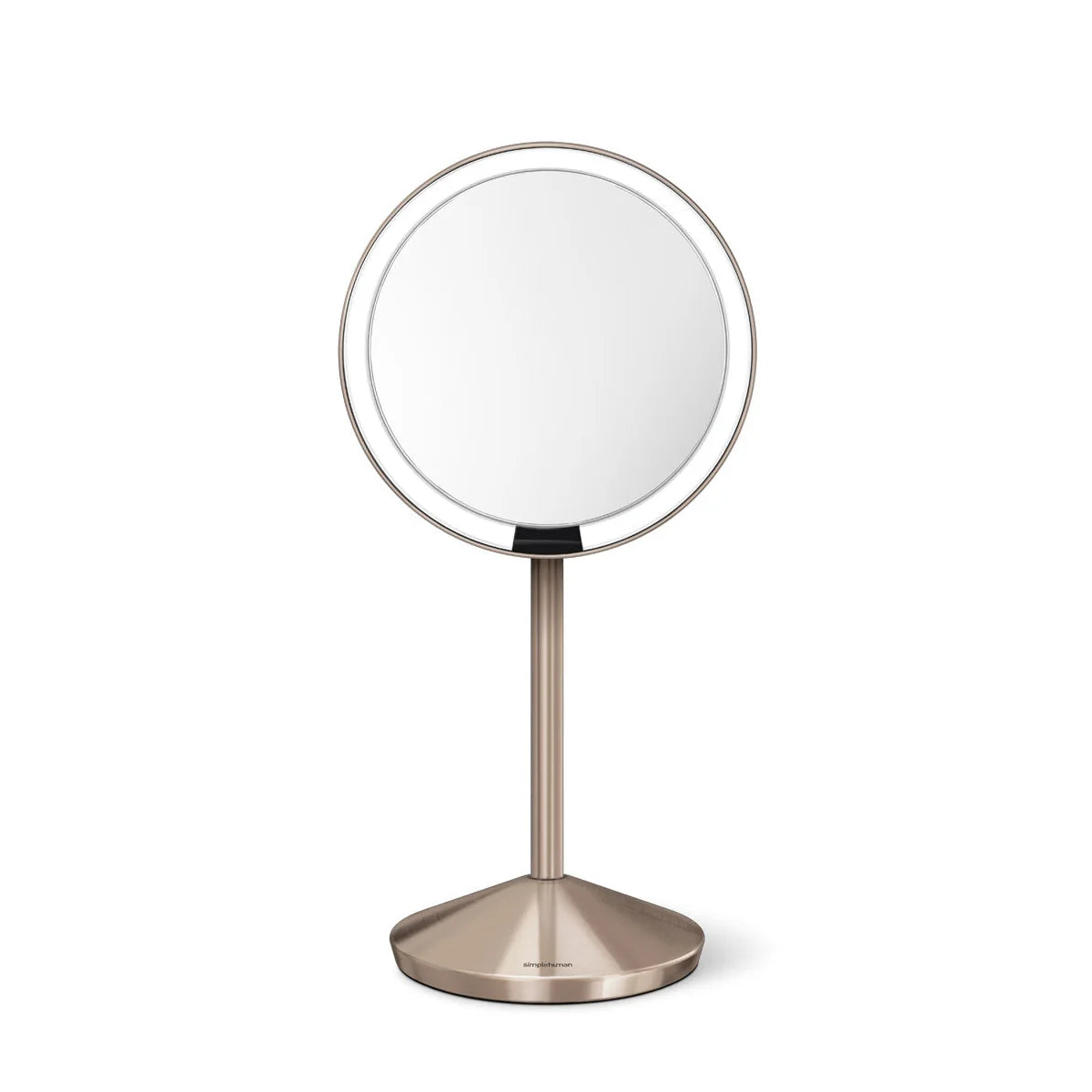  A front-facing view of a sleek, circular vanity mirror mounted on a slim, brushed gold metallic stand. The mirror has a thin bezel, providing a large reflective surface that offers a clear and accurate view. The base is sturdy and weighted, with a matching brushed finish, ensuring the mirror stands securely on a vanity or countertop. The design is modern, elegant, and suitable for a contemporary setting.