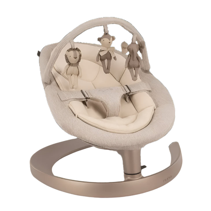 A beige baby rocker with a curved metallic base, cushioned seat, and a toy bar featuring three soft hanging plush animals—a lion, monkey, and elephant—for infant entertainment.