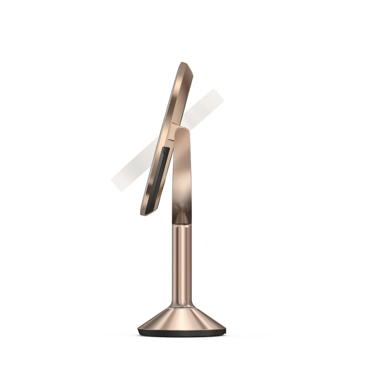 This image shows a side profile of the Simplehuman makeup mirror in a rose gold finish. The mirror is shown in a slightly tilted position, emphasizing its adjustable tilt feature, which allows users to customize the angle for optimal use during makeup application or grooming.  The design is sleek and modern, with a thin, elegant frame surrounding the mirror. The stand is slender yet sturdy, tapering into a stable base that ensures the mirror remains secure on any surface. The rose gold color adds a luxuriou