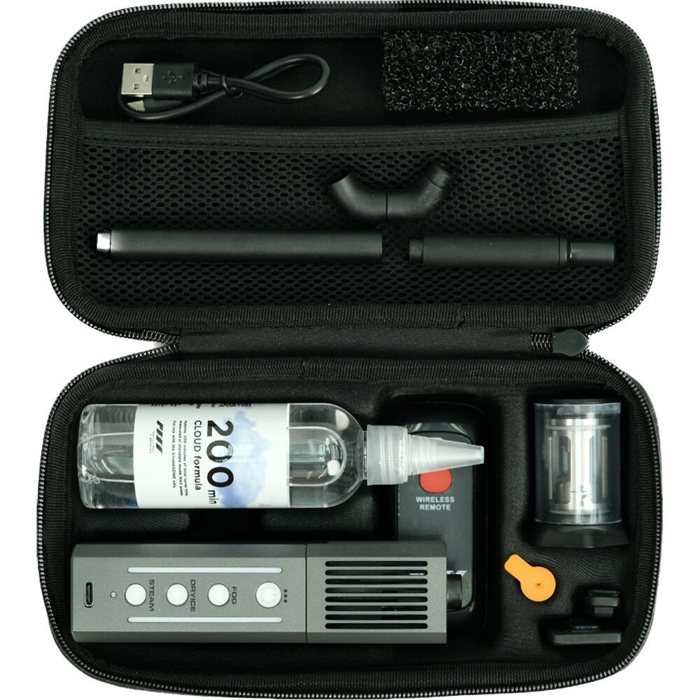 This is an open view of a carrying case containing the complete Smoke Ninja Full Kit. The components are neatly organized in compartments, including a bottle of smoke fluid, the smoke-emitting device, various nozzles and attachments, a wireless remote, and other accessories like a USB charging cable. This portable smoke effect tool is designed for use in photography and filmmaking to create controlled smoke effects during shoots.