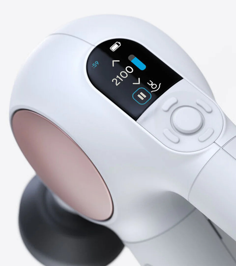 Close-up of a white handheld massage device featuring a digital display showing speed settings, battery level, and operation status, with sleek ergonomic controls and a modern design.