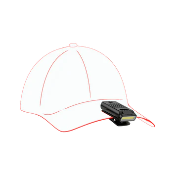 A compact black LED clip light attached to the brim of an illustrated outline of a baseball cap. The light features a long, narrow LED strip at the front, a textured grip area, and an attached clip for easy attachment to the cap, demonstrating its hands-free functionality.