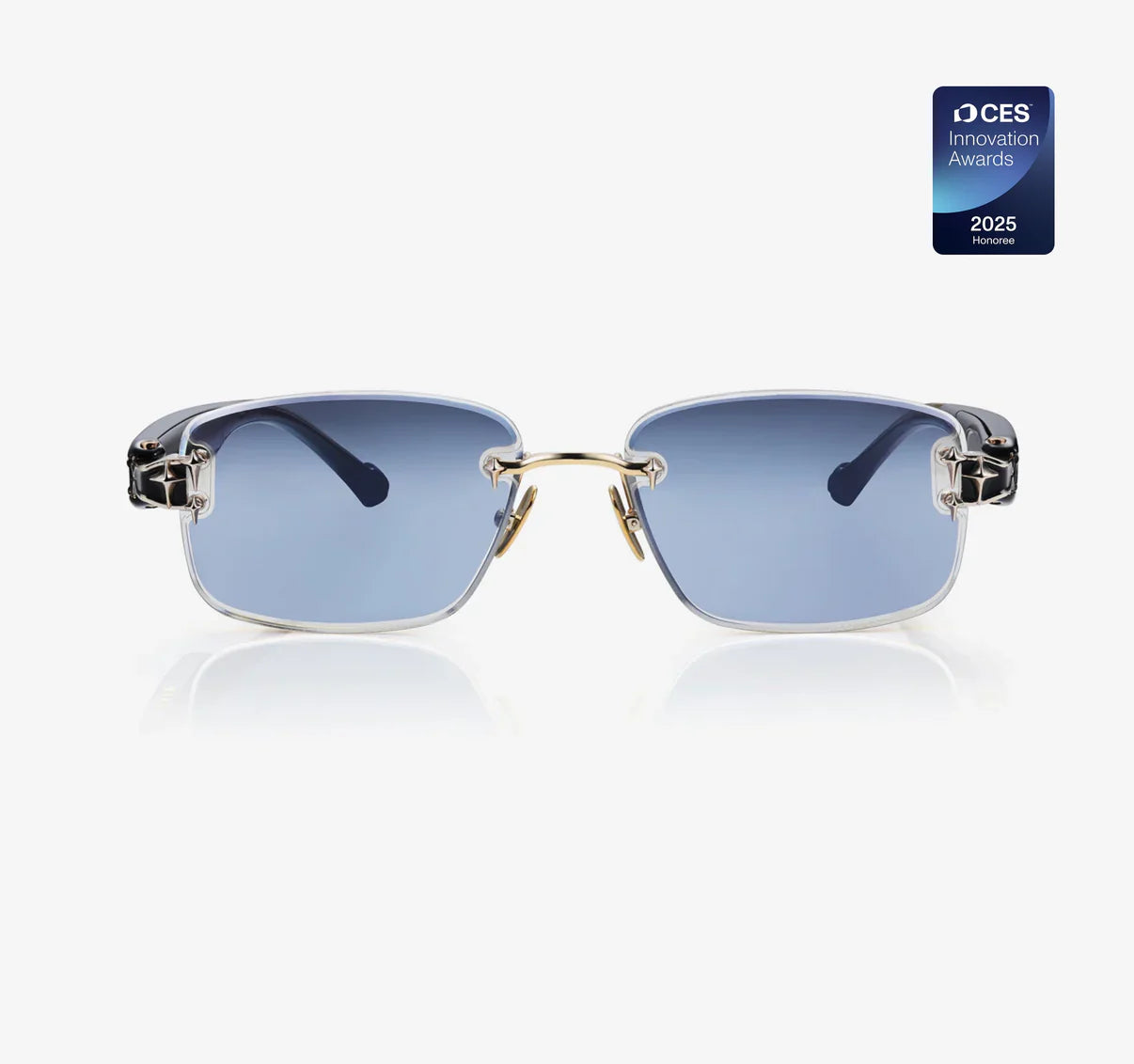 These sunglasses feature a sleek semi-rimless design with blue-tinted lenses, a gold bridge, and innovative styling, awarded at CES 2025 for excellence.