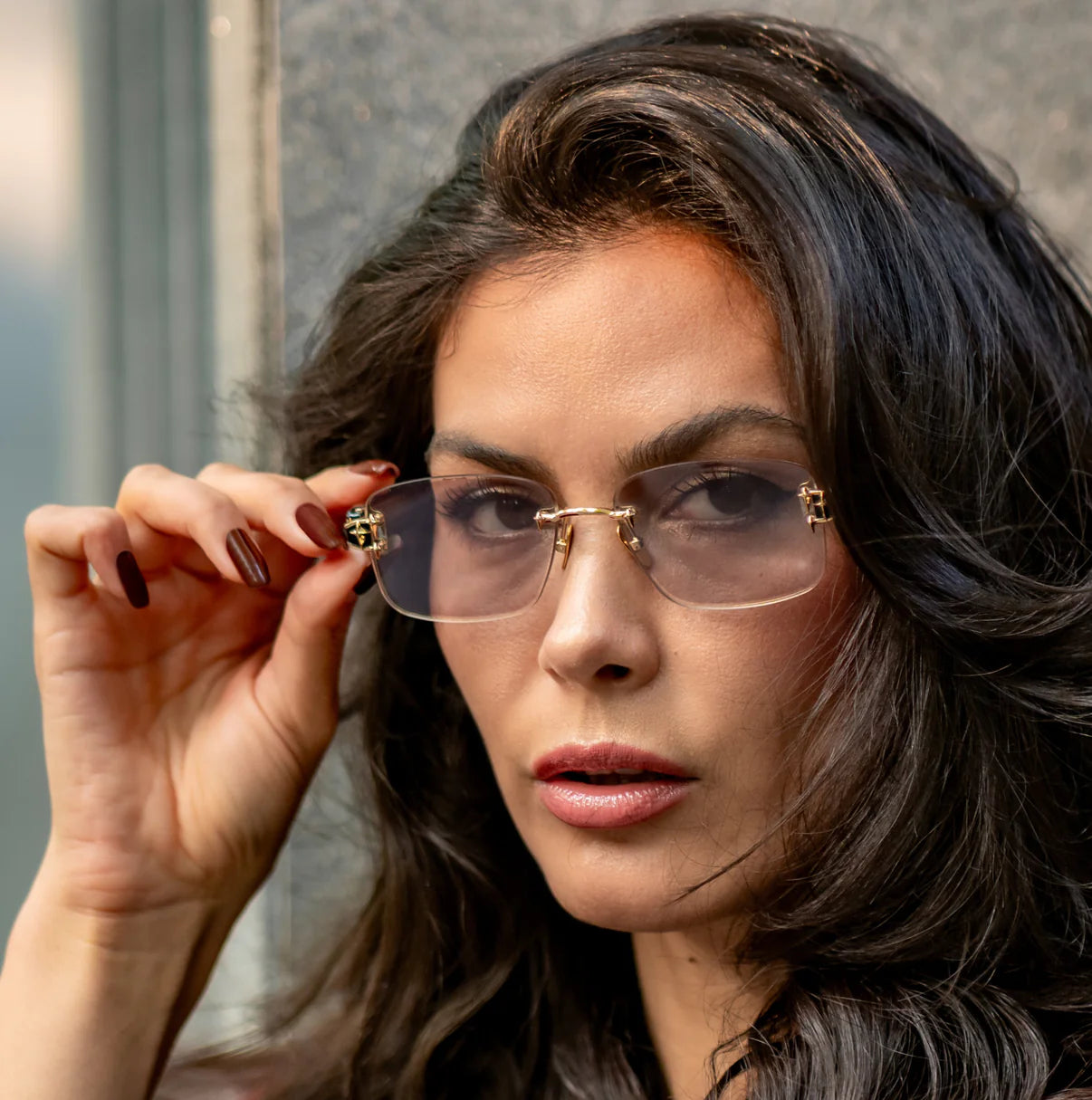 These stylish glasses feature a gold frame with tinted lenses, adding a sophisticated touch to your look.