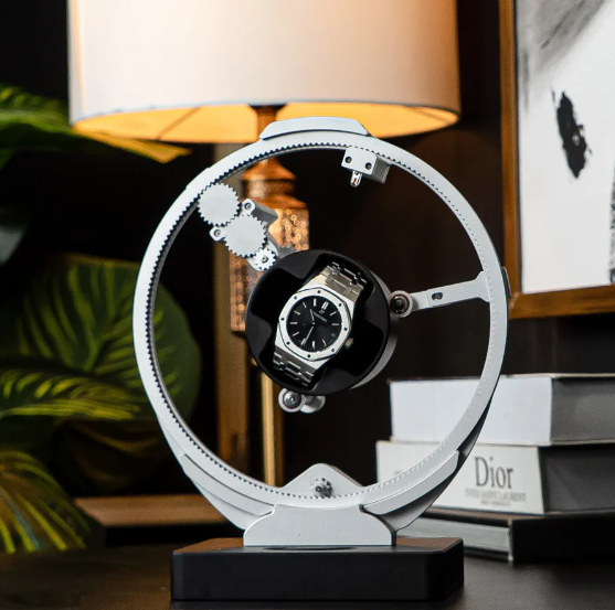 Modern automatic watch winder, sleek silver design, advanced rotation system, ideal for displaying and keeping watches wound in style.