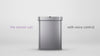 The image is a still frame from a video featuring a Simplehuman sensor trash can with voice control. The can is centered in the frame, and the text "the sensor can" is written on the left side in purple, while "with voice control" is on the right side in black. The trash can has a sleek, modern design with a brushed stainless steel finish. The sensor area is visible at the top center of the lid, indicating where it detects motion or listens for voice commands. This product combines hands-free operation with