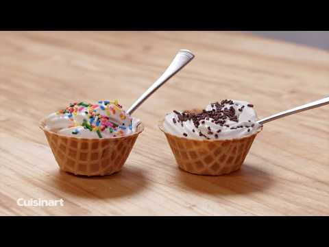 Two waffle cups filled with vanilla ice cream, one topped with rainbow sprinkles and the other with chocolate sprinkles, next to spoons.