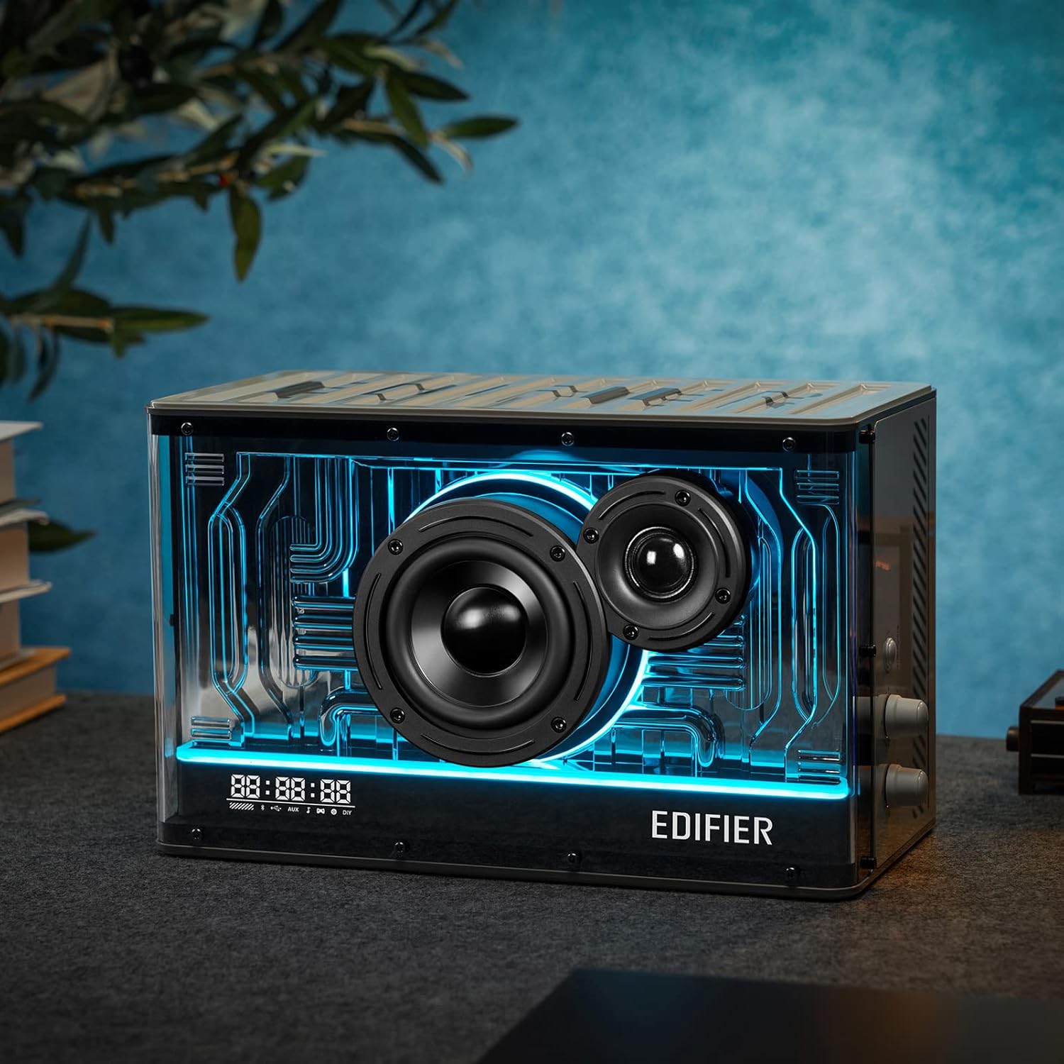 This image showcases an Edifier speaker with a futuristic design featuring a transparent enclosure that reveals its internal components, accented by vibrant blue LED lighting. It combines aesthetic appeal with functionality, making it a striking centerpiece for modern audio setups. The front display indicates time and other settings, suggesting it includes smart or digital features.