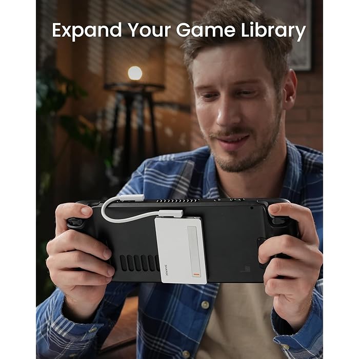 A gamer holding a handheld gaming console with a SHARGE power bank attached at the back, connected via a white cable. The setup emphasizes extended power support for gaming, allowing users to expand their game library and play longer without interruptions.